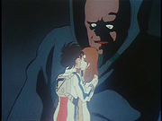 The supreme Zentradi commander, , towers over the humans,  and , and also experiences culture shock at the sight of their kiss.