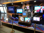 The actual display in the Tembo Galleria, featuring old and new television screens playing Macross.