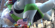 Buzz Lightyear's arm was caught on a flagpole of the Santaland Express, but he was freed without any damages to the balloon.