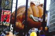A tailless Garfield balloon with a damaged paw tries to make it down Broadway in the 1997 Parade. (Photo: George Loper)