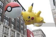 Pikachu with PokéBall balloon arrives at 34th Street, at the 2010 Parade.