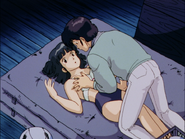 Yagami forces Godai into falling with his hand on her chest