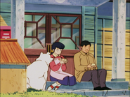 Kyōko and Zenzaburo Mitsukoshi share a bun at the doorstep