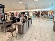 Lower-level makeup and beauty department, by lower level mall entrance.