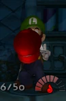 Luigi holding Mario's Hat.