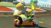 Armed with a , the Yellow Yoshi races the track.