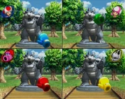 The players participating in punching the Bowser Statues.