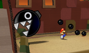 Mario dodging a big Chain Chomp.