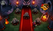 The four players weave around the Bowser Statues once again.