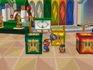 Mario prepares to whack a large green block with his hammer.