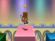 Mario collects a coin from a Brick Block.