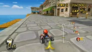 Mario Kart Wii screenshot of Mario driving near the pier