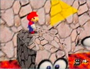 Mario standing on a Pushy Wall.