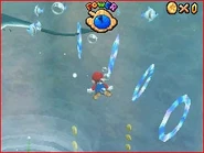 Mario approaching the Manta Ray and his Rings.