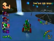 Yoshi and Toad drive past a Waterspout in the cave. They made it!