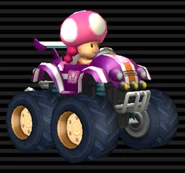 Toadette's Tiny Titan, magenta with white stripes, pink emblem, orange stripe through, hub caps are tinted orange.