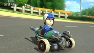 A Male Mii racing with a Tri-Speeder.