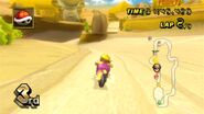 Wario racing at Dry Dry Ruins in his Spear.