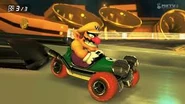 Wario racing though Music Park while using a Tri-Speeder.