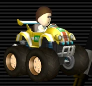 Female Mii's Tiny Titan, yellow with white stripes, green emblem, orange stripe through, tires are tinted brown, hub caps are tinted brown.