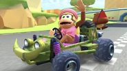 Dixie Kong waving at 3DS Toad Circuit in her Offroader in Mario Kart Tour.