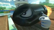 A Bullet Bill racing on Donut Plains 3 in Mario Kart 8.