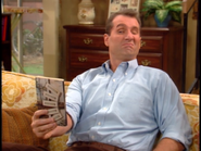 Al attempting to make out who is on the cover of the TV Guide in "If I Could See Me Now".