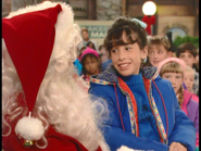 As Samantha, who is telling Al Bundy, the mall Santa what her Christmas wish is.
