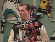 Al holding a "Big 'Uns" that has the full title of "Girls with Big 'Uns" in the episode "Kelly Knows Something"