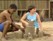 As the kid who builds a sandcastle that Al eventually destroys