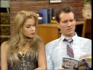 Al and Kelly looking at the TV Guide during "TV Family Time" in "Peggy Made a Little Lamb".