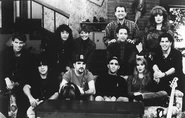 A promotional picture featuring the band and the cast of Married... with Children.