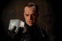 Schmidt holds up the fake Tesseract