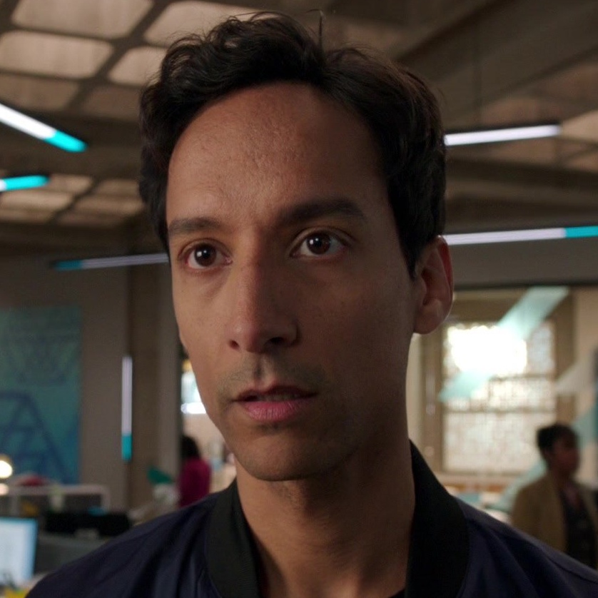 Pictured: Danny Pudi as Teddy from the Powerless episode "Wayne or...