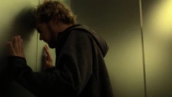 DRand-HoldingHimselfOnAnElevator-Wall