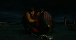  is comforted by  and  on Midtown's roof