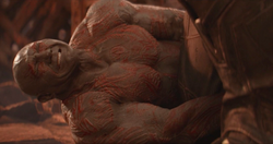 Drax holds ' leg so he can't escape
