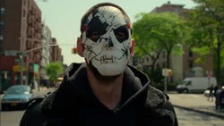 Jigsaw wears his mask during a robbery