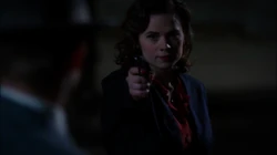 Carter holds a gun at 