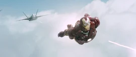 A United States Air Force F-22 Raptor engages Iron Man in a dogfight.