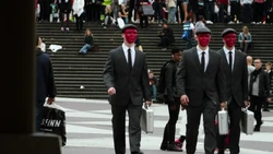 The masked men walk through 