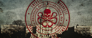 This symbol appeared in the archive accessed by the preserved mind of Dr. Arnim Zola. The center features the traditional Hydra skull & tentacles, while the next circle of text written in German and in Blackletter font reads "Hydra Department by appointment of the Führer". The text in the peripheral circle reads, from the top left and going clockwise: "Power. Truth. Determination. Strength."