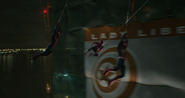 Three Spider-Men swinging