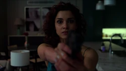  aims her gun at 
