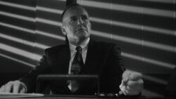 Coulson handcuffed to a table