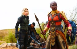 Okoye wields her spear next to 