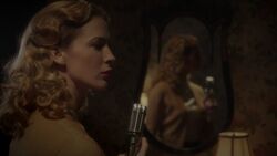  admiring the pistol in the mirror