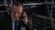 Agent Coulson talking with Natasha.