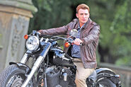 Rogers arrives at central park on his motorcycle.