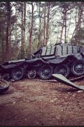 Set photo of a destroyed Tank on set in Hampshire Woods, UK